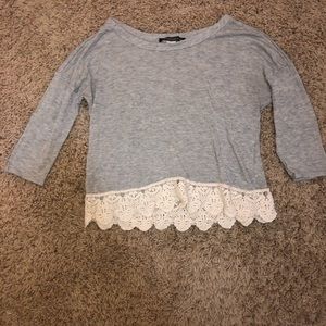 Grey top with white lace detail at the bottom